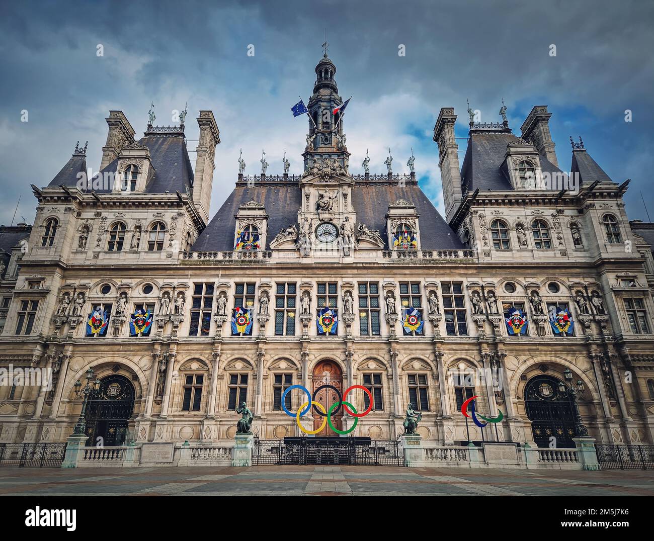 Paris City Hall, France. Outdoors view to the beautiful ornate facade of the historical building and the olympic games rings symbol in front of the ce Stock Photo
