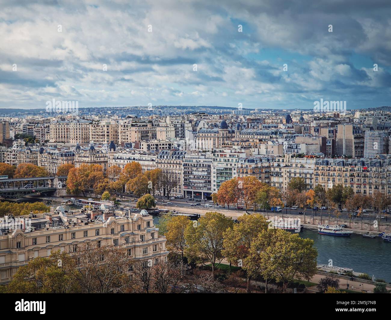 Paris cityscape over the Seine river, view from the Eiffel tower height, France. Fall season scene with colorful yellow trees Stock Photo