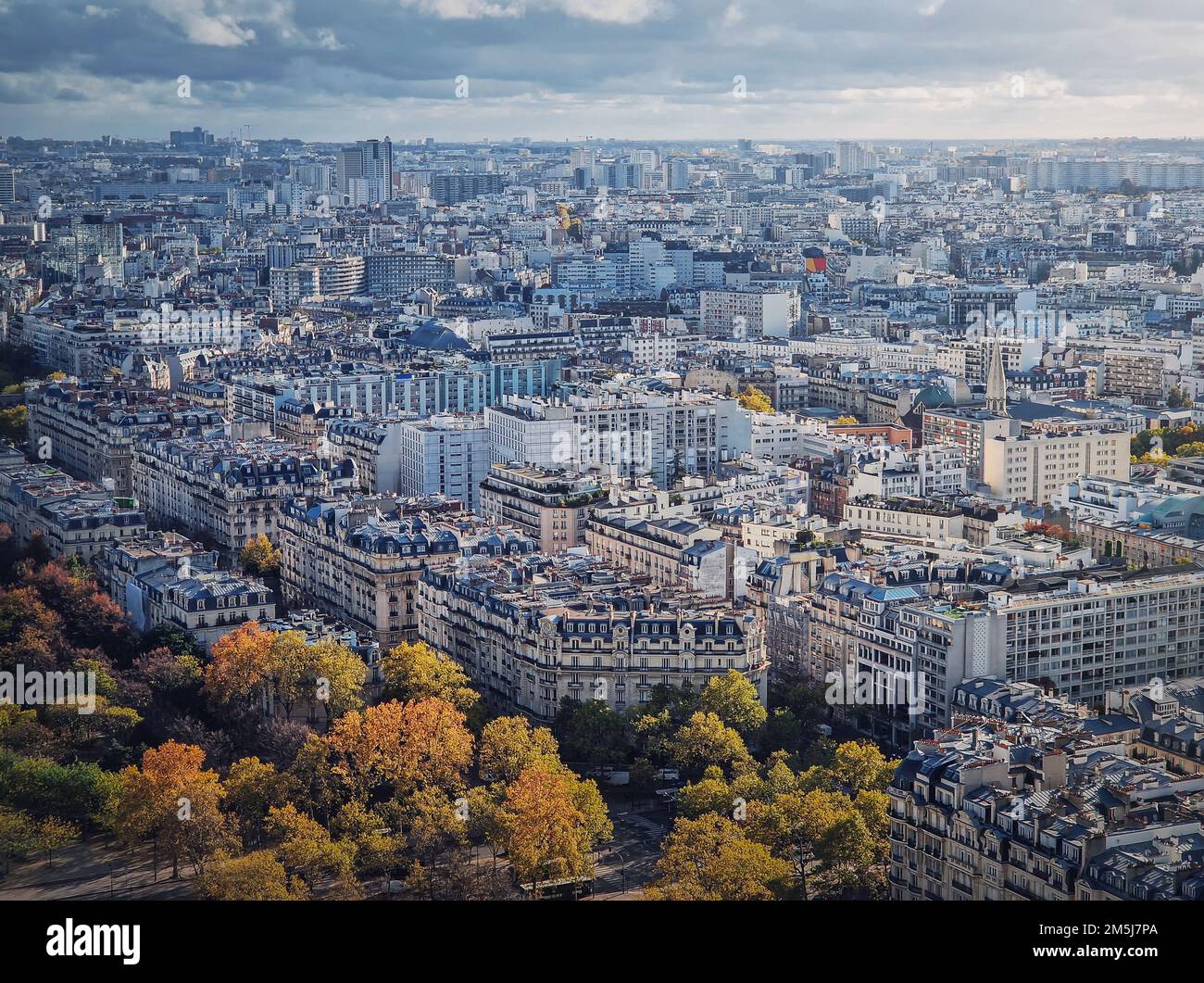 Paris cityscape view from the Eiffel tower height, France. Fall season scene with colored trees Stock Photo