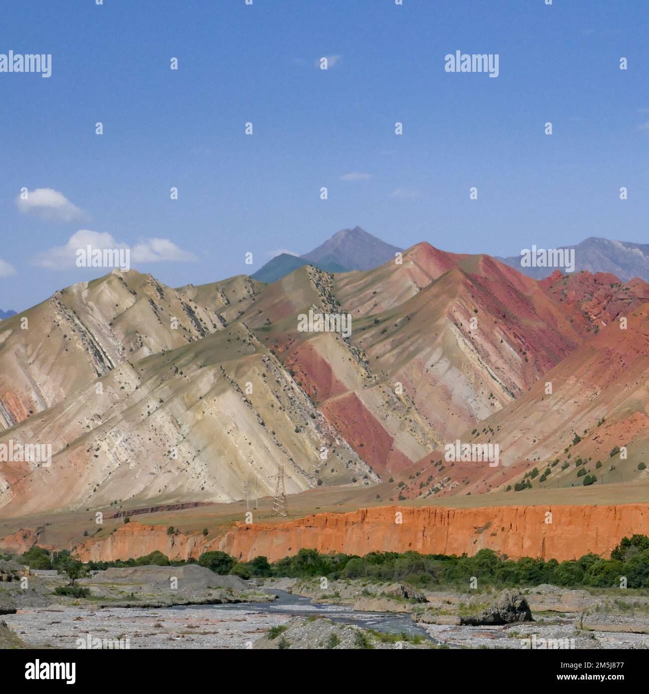 Landscape view of colorful red and orange rock strata in the Alay or Alai mountain range along Pamir Highway, Gulcha river valley, southern Kyrgyzstan Stock Photo