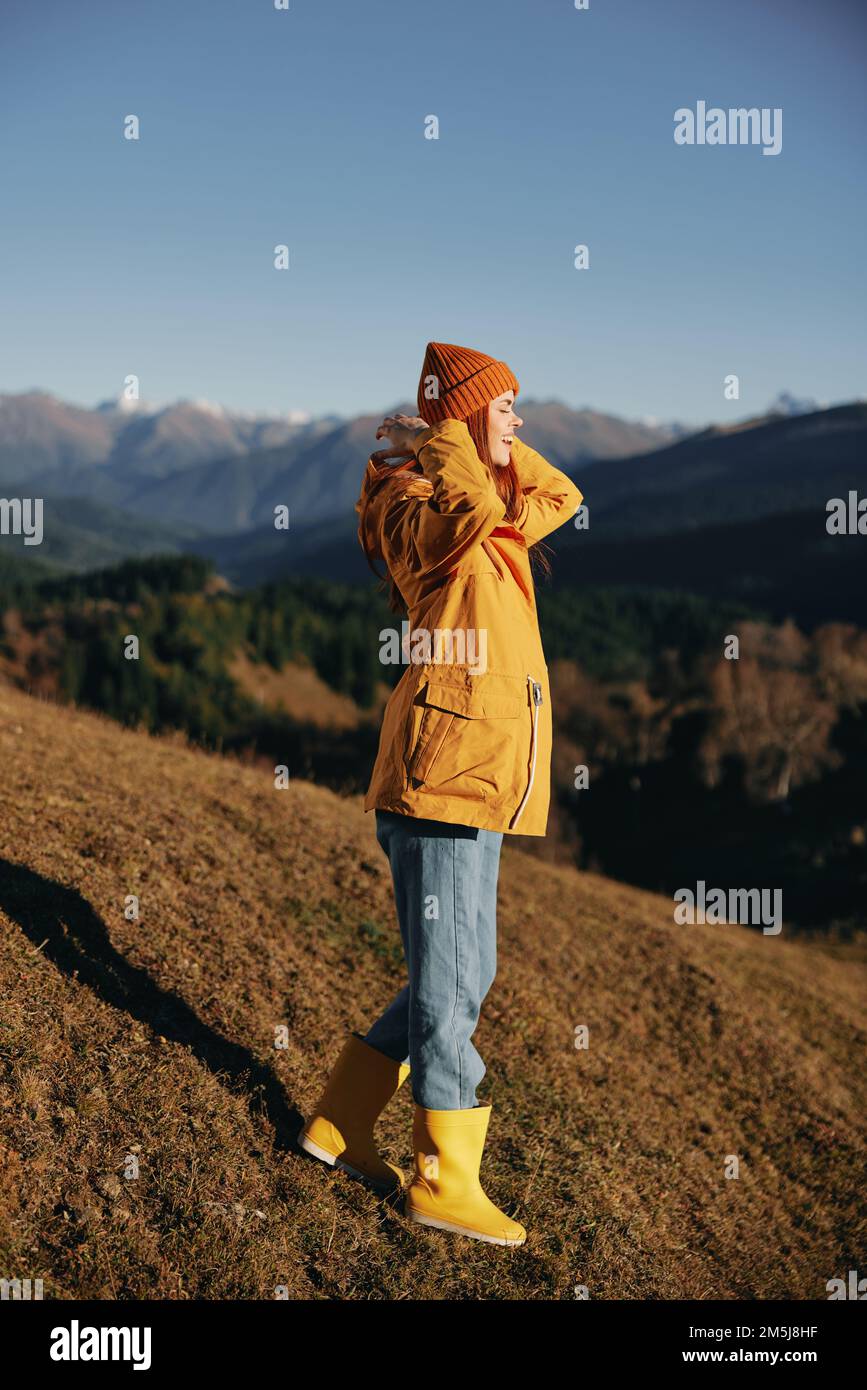 Woman in the autumn smile with teeth full-length walk on the hill and ...