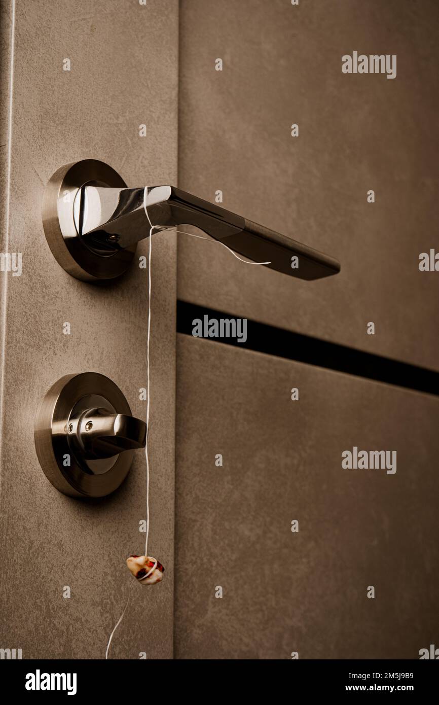 Real human teeth hanging on the door handle. Pulled out tooth