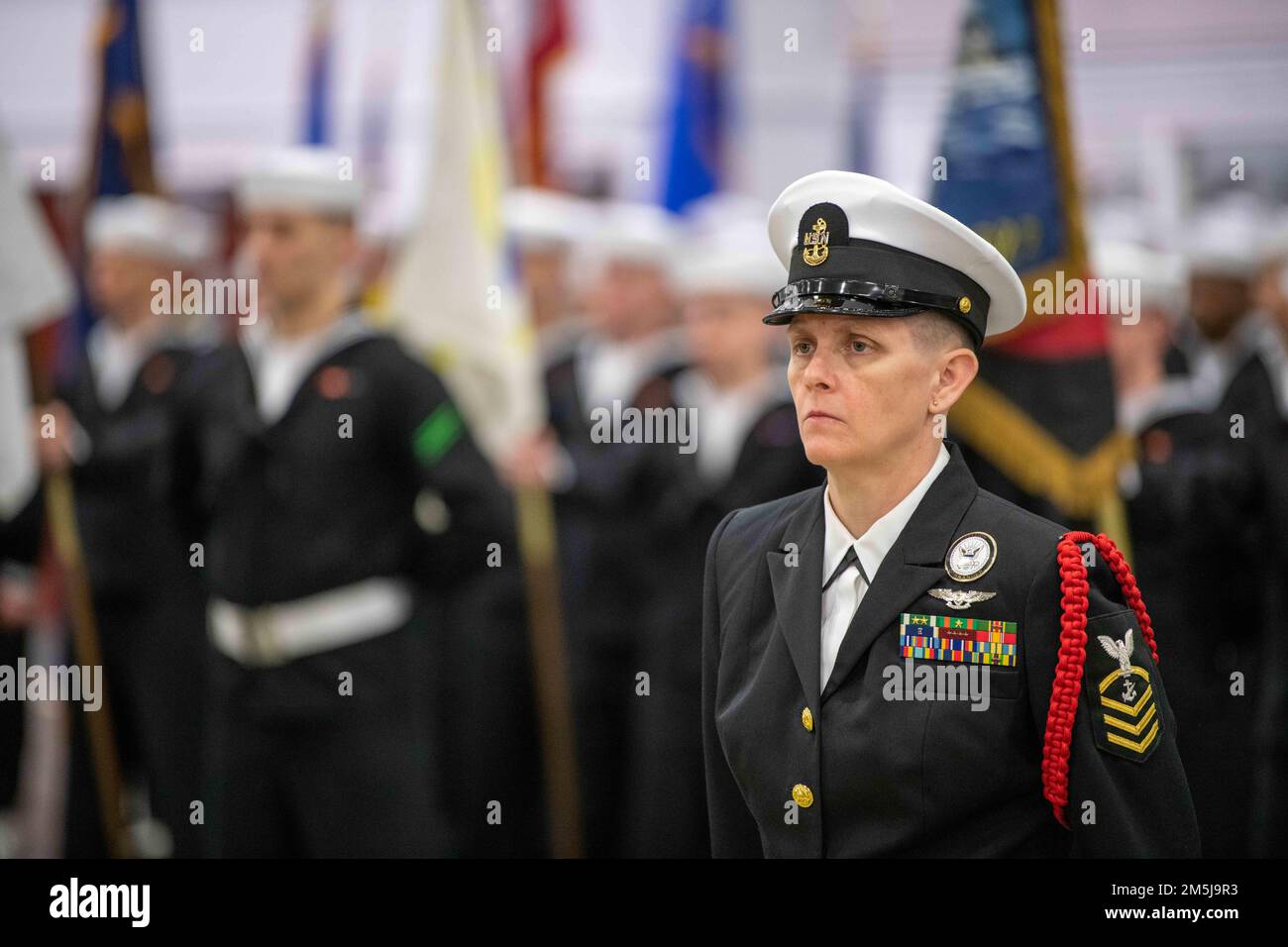 Chief Navy Counselor Kelly Ringaman, a recruit division commander, stands at parade rest inside Midway Drill Hall during a pass-in-review graduation ceremony at Recruit Training Command. More than 40,000 recruits train annually at the Navy's only boot camp. Stock Photo