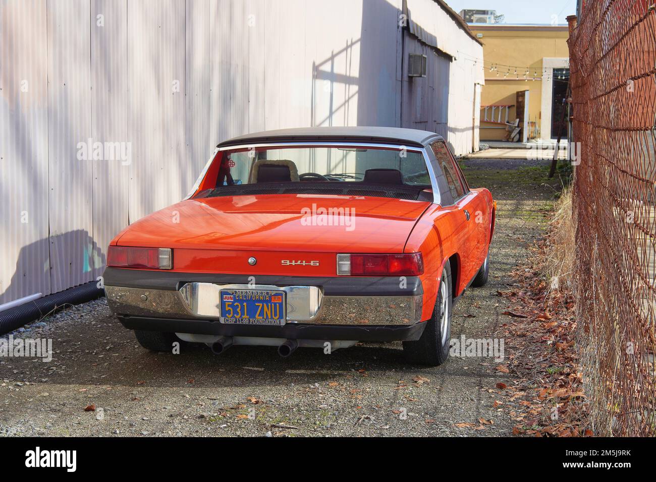 Vintage Porsche 914-6 classic car rear view with red paint parked in an alley in Healdsburg, Sonoma County, California. Stock Photo