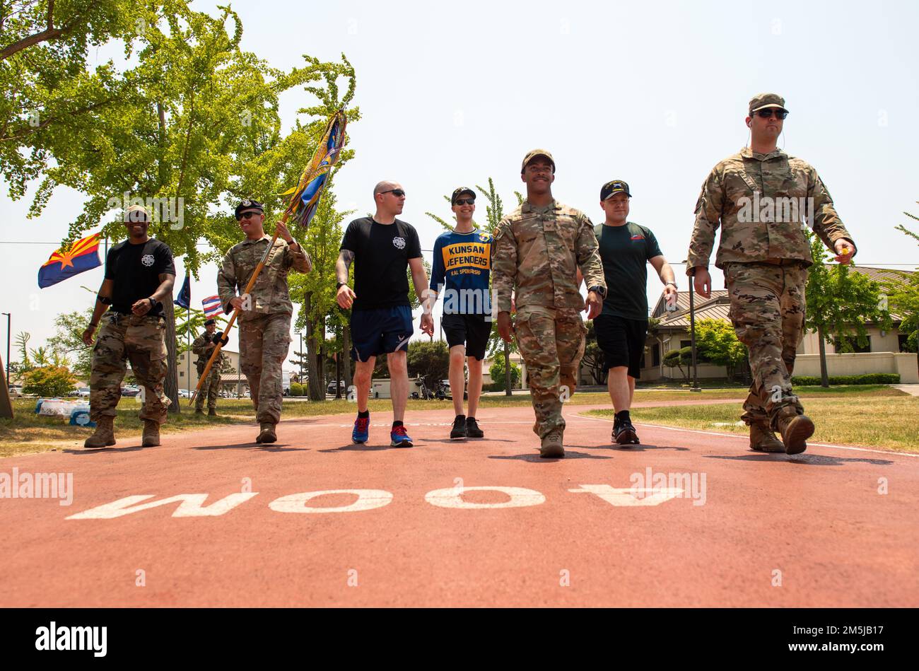 Members of the 8th Security Forces Squadron march together during a 24-hour memorial run/walk for Police Week 2022 at Kunsan Air Base, Republic of Korea, May 18, 2022. National Police Week pays special recognition to law enforcement officers who have lost their lives in the line of duty for the safety and protection of others. Stock Photo