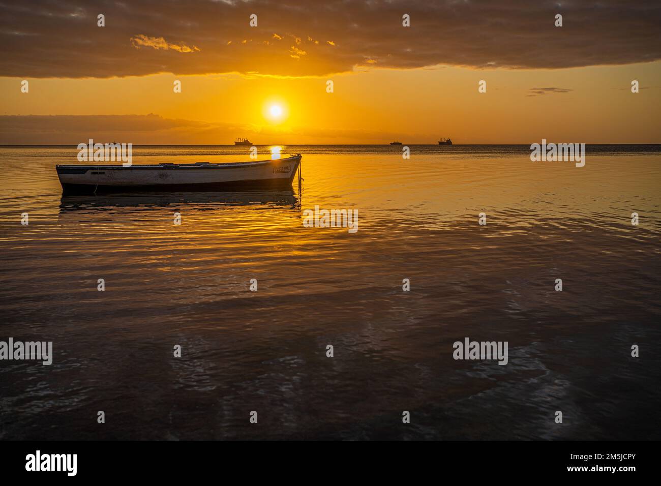 BaieduTombeau Mauritius Sunset over the bay with single fishing boat