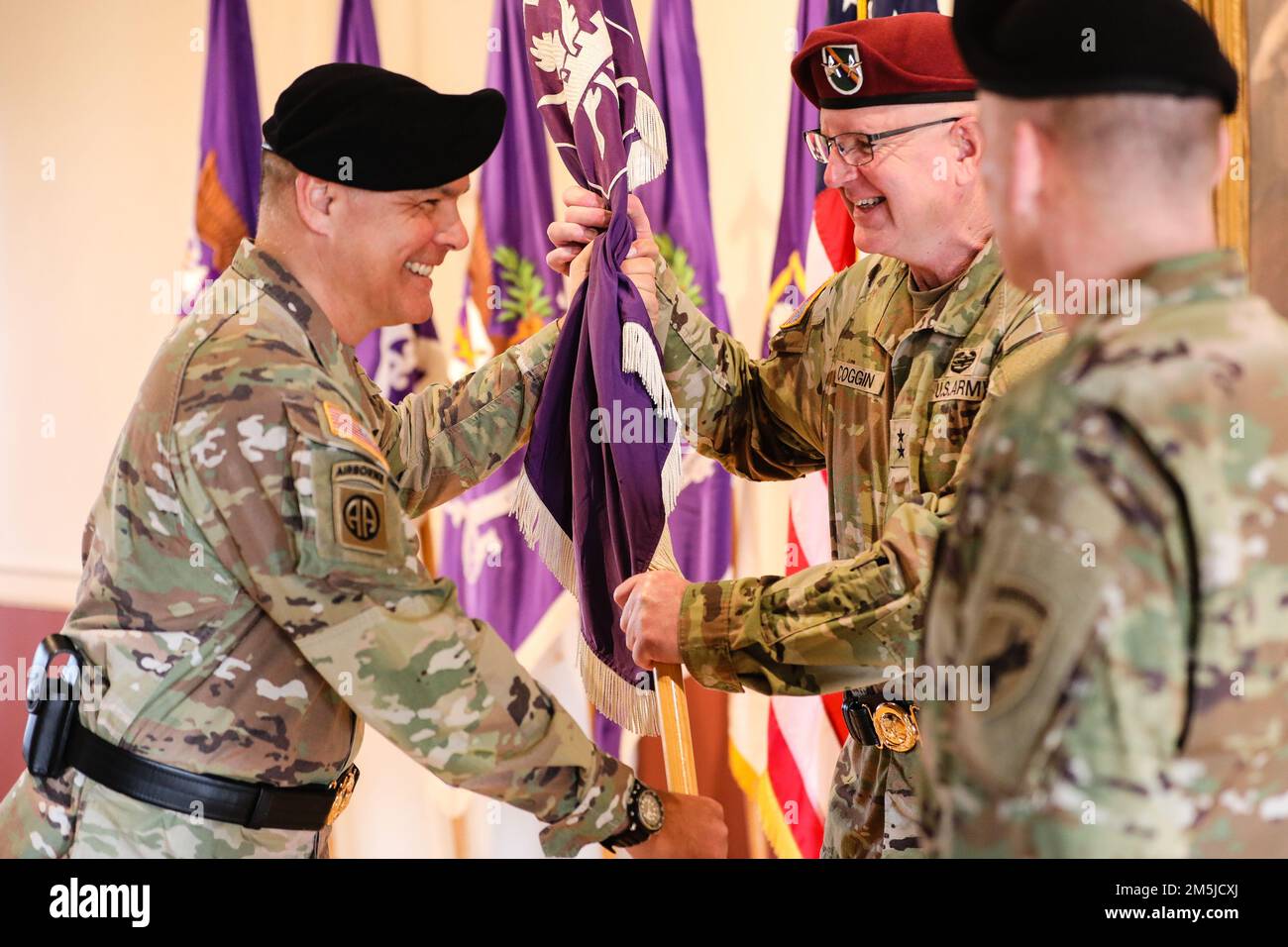Brig. Gen Timothy Brennan, left, the outgoing commander of the 353rd Civil Affairs Command, passes a unit guidon to Maj. Gen. Jeffrey Coggin, commanding general of U.S. Army Civil Affairs and Psychological Operations Command, during a change of command ceremony at Fort Hamilton, N.Y., March 19, 2022. During the ceremony Brig. Gen Timothy Brennan relinquished command to Brig. Gen. Dean Thompson. Stock Photo