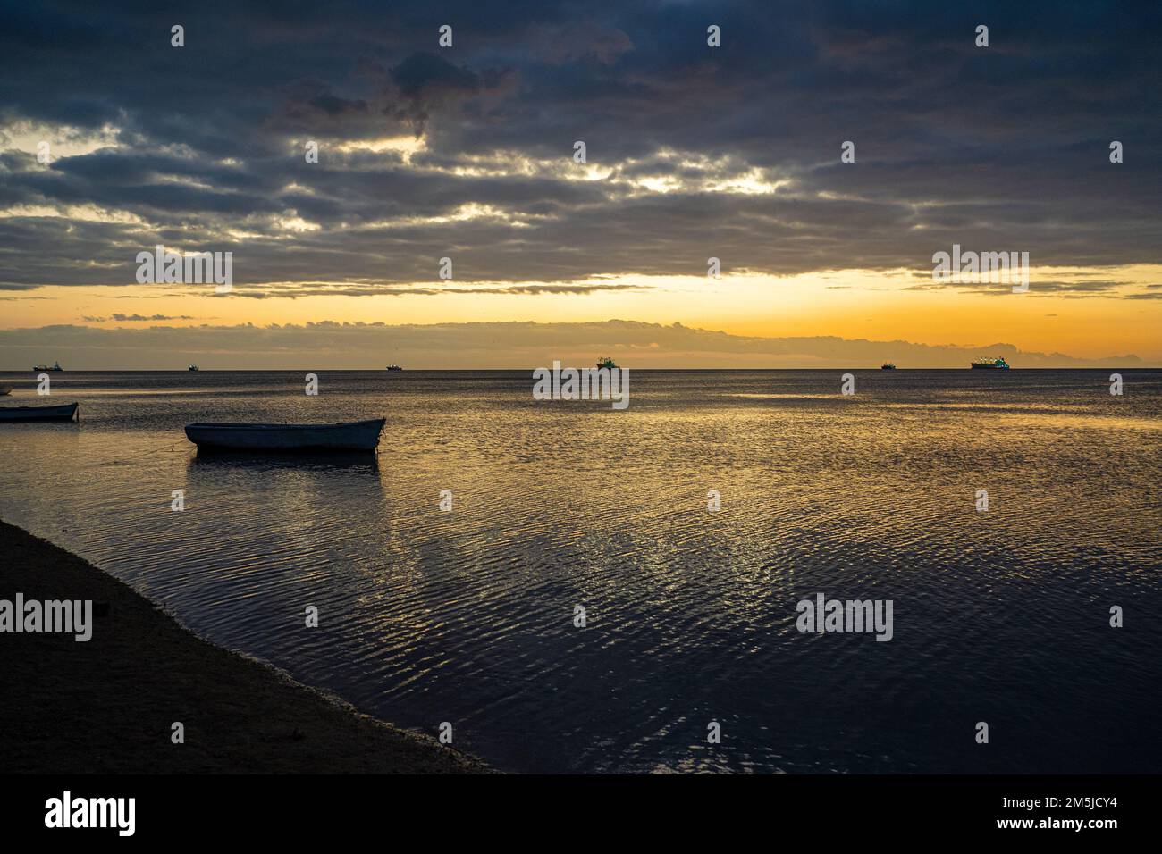 BaieduTombeau Mauritius Sunset over the bay with single fishing boat