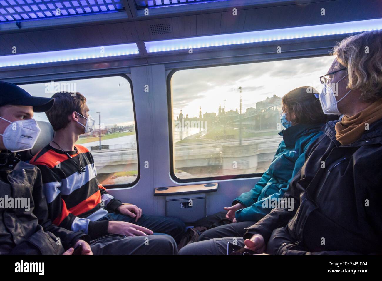 Dresden: passengers at top floor of S-Bahn train wearing FFP2 masks, view to Dresden city center and river Elbe in , Sachsen, Saxony, Germany Stock Photo