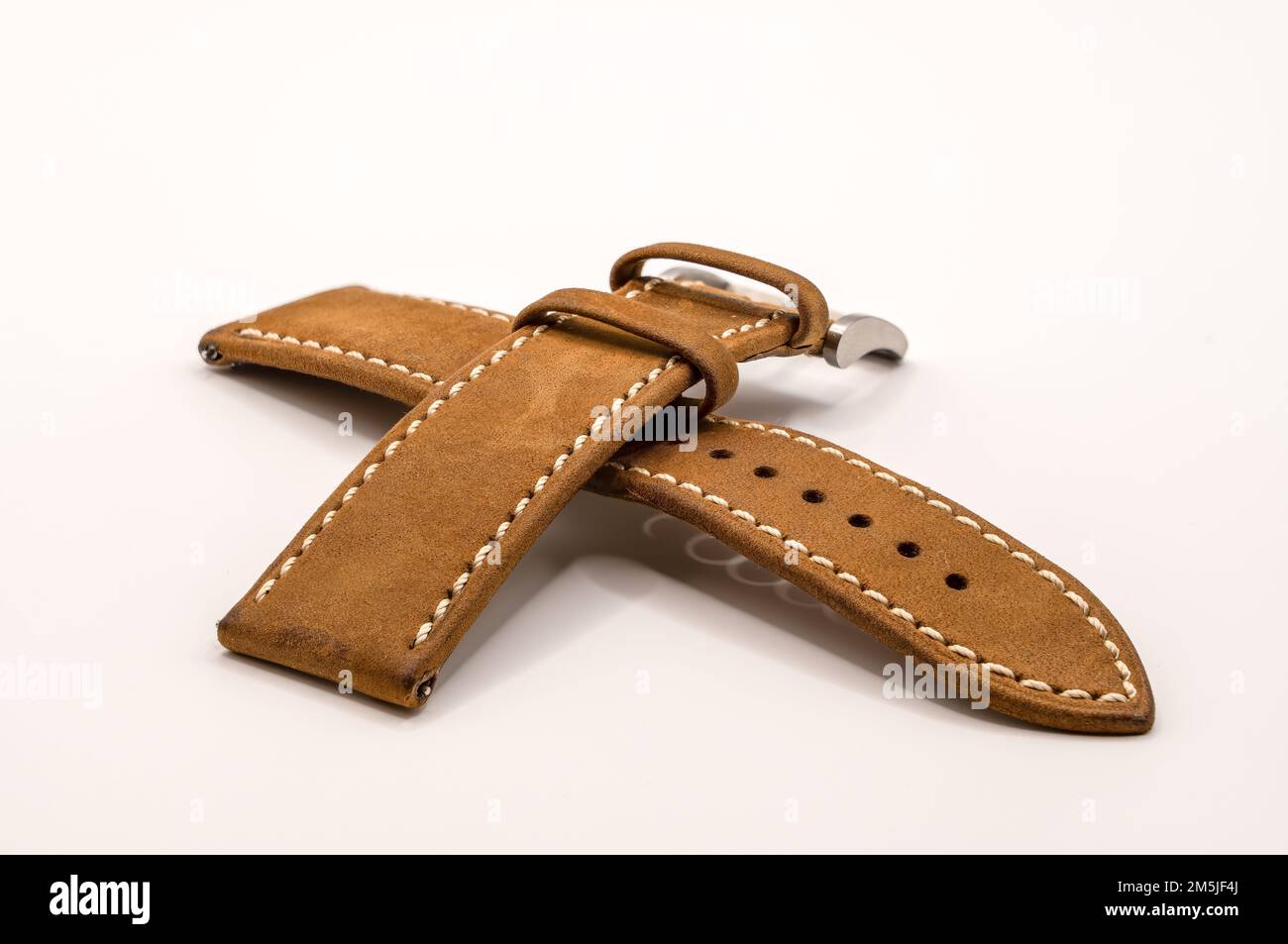 detailed close up of a vintage camel oak leather watch strap with brushed stainless steel metal