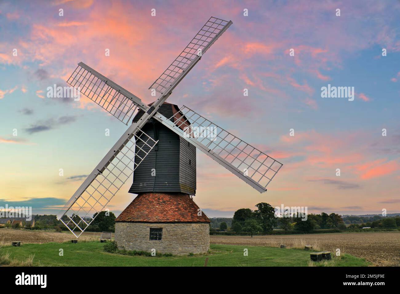 18th century windmill in a field on farmland in the village of Stevington at sunset, Bedfordshire, England, UK Stock Photo