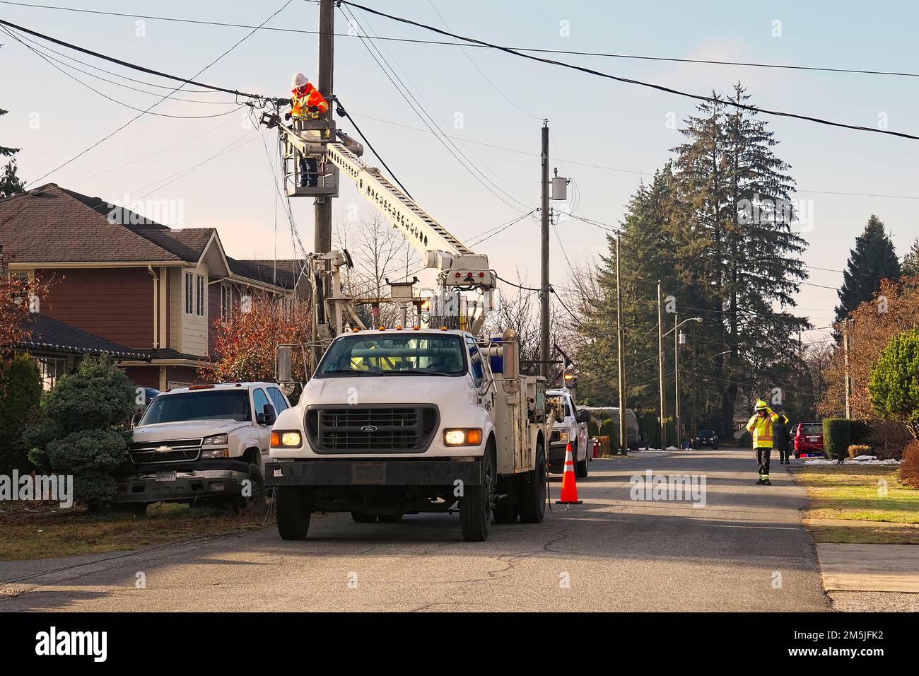 Electrician hooking up Fiber Optic cable to a utility pole in Maple Ridge, British Columbia, Canada. Stock Photo