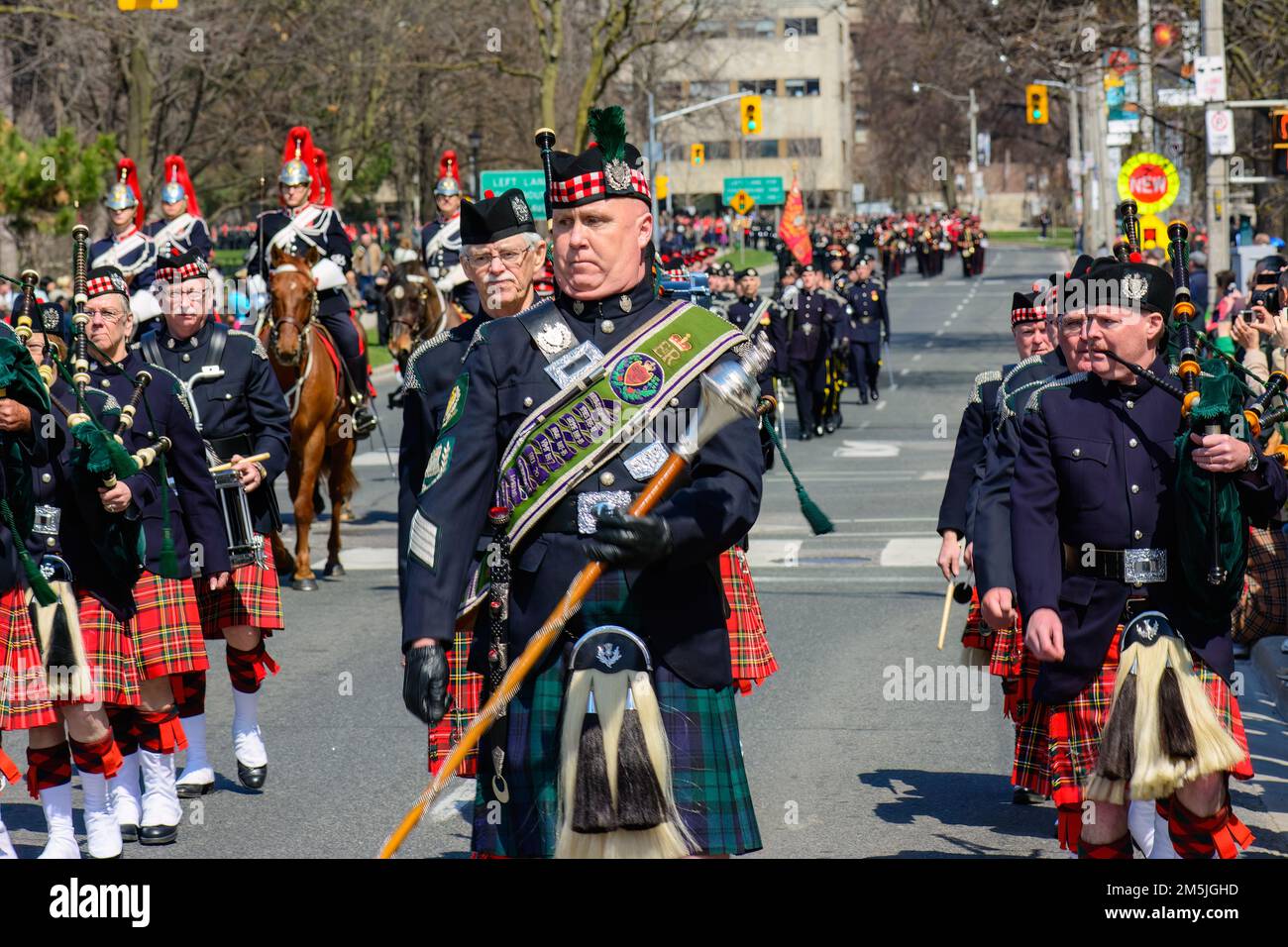 A music band from the Scottish regiment performs as they march in the city streets. Stock Photo