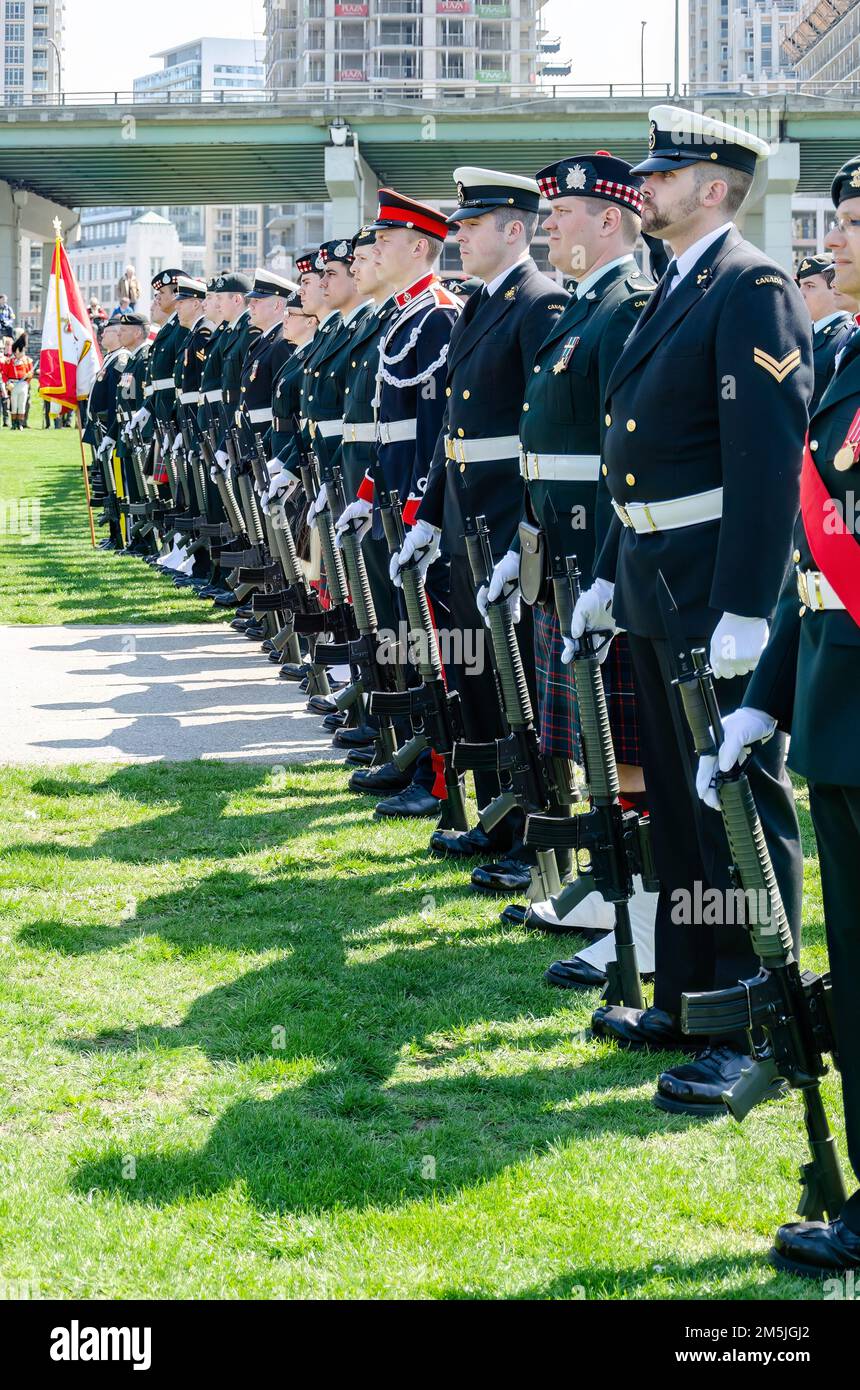 Members of the current Canadian Armed Force or Army are formed in Fort York. They are partaking in the celebration event. Stock Photo