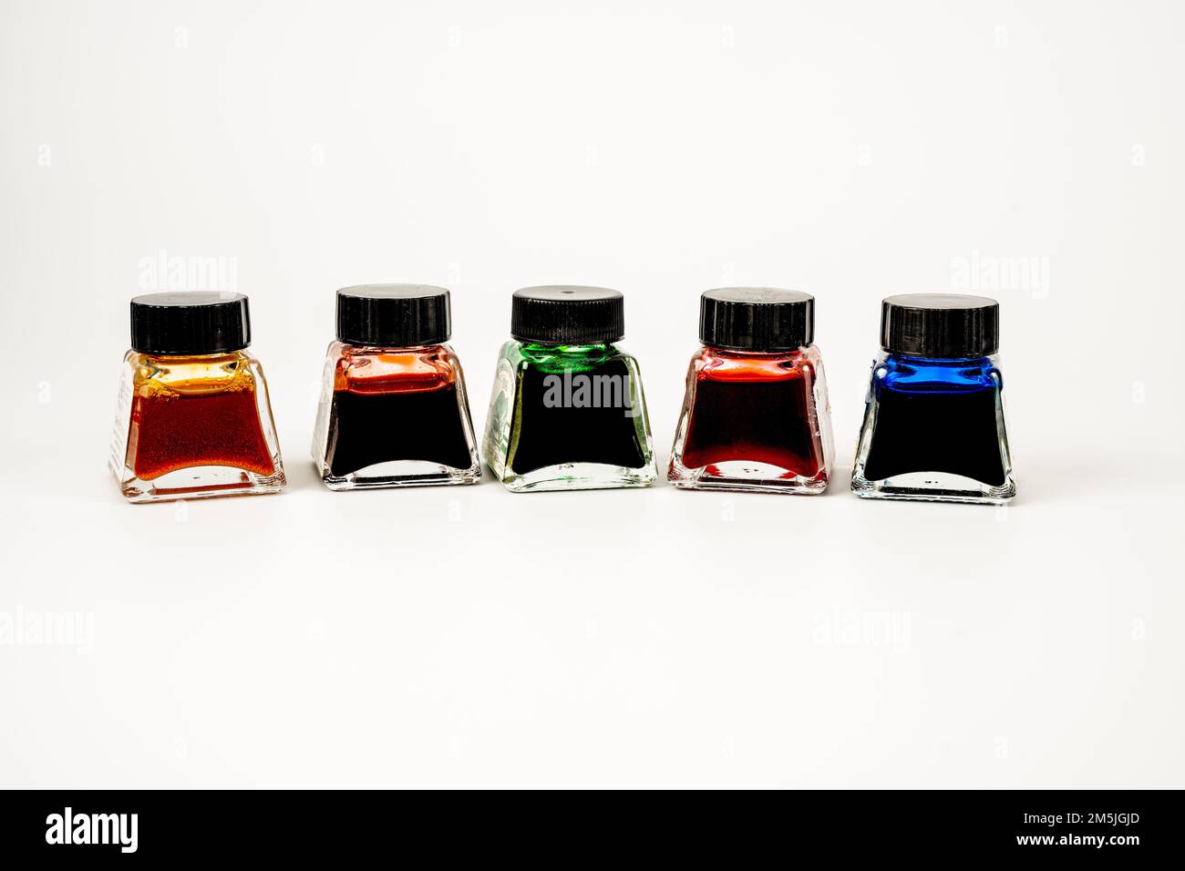selection of artists india ink in glass bottles isolated on a white