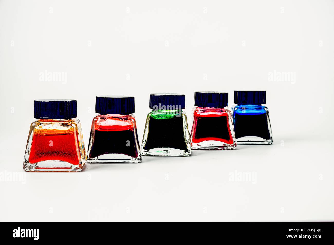 set of artists india ink colors in glass jars bottles isolated on a