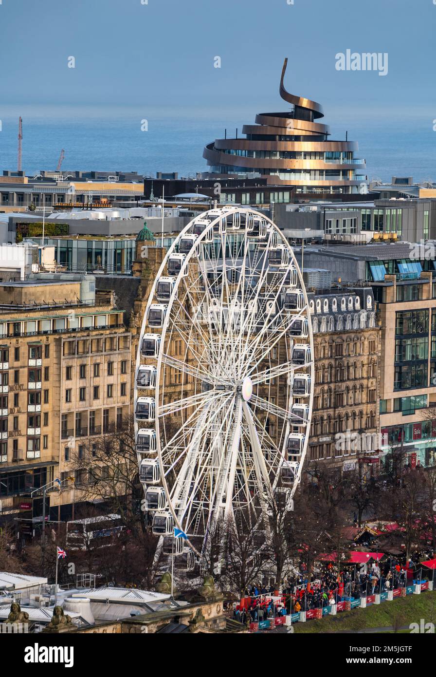Big Ferris Wheel in Christmas market, Princes Street Gardens, and St James Quarter rooftop, Edinburgh, Scotland, UK Stock Photo