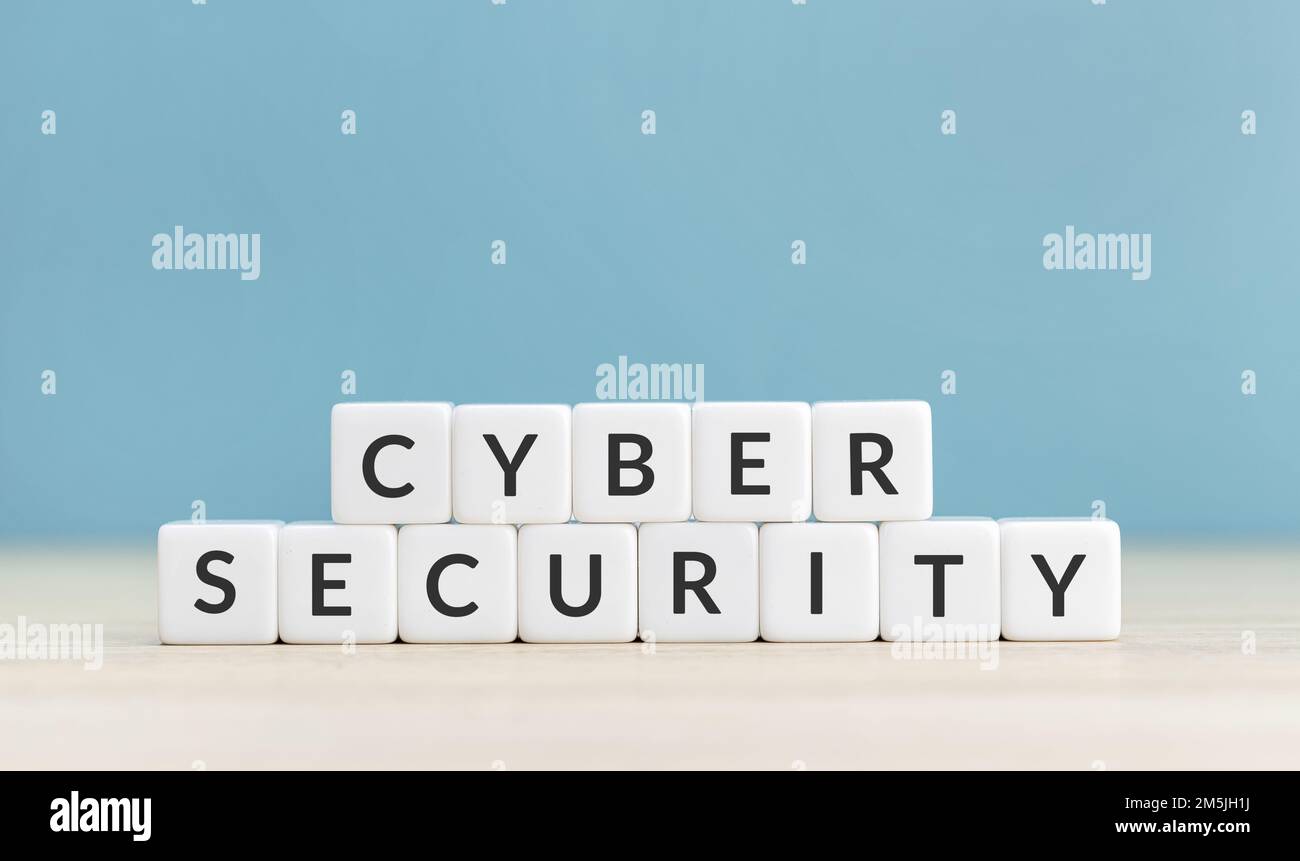 Cyber security concept. Text on cube blocks on blue background. Copy space Stock Photo