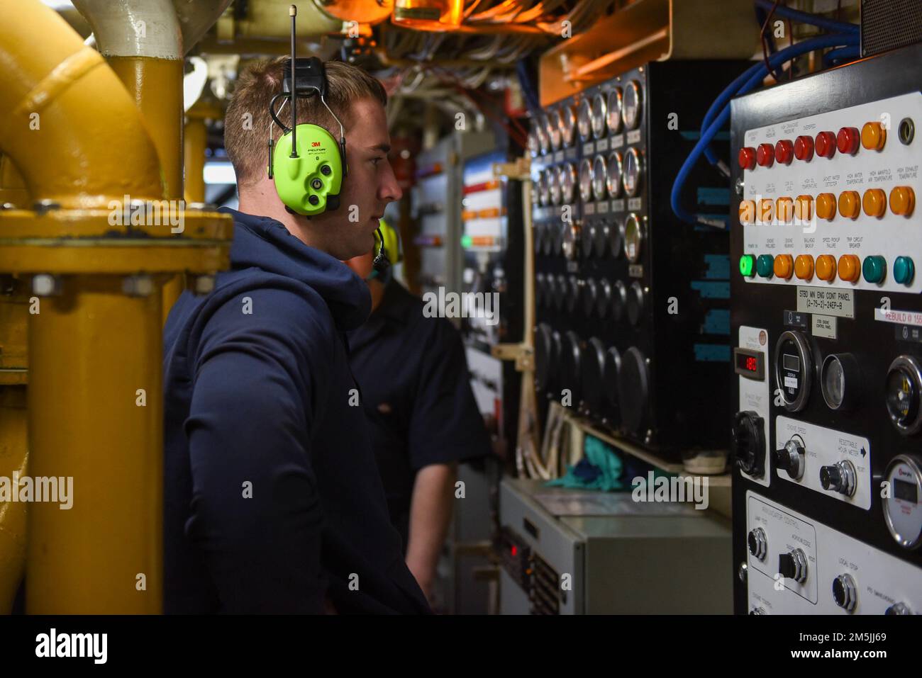 U.S. Coast Guard Petty Officer 3rd Class Michael Covey, a Machinery Technician aboard Coast Guard Cutter Spar, monitors the main starboard engine control panel while underway in the Atlantic Ocean, March 19, 2022. Spar and her crew are traveling to Duluth, Minn. after a year-long maintenance period in Baltimore. Stock Photo