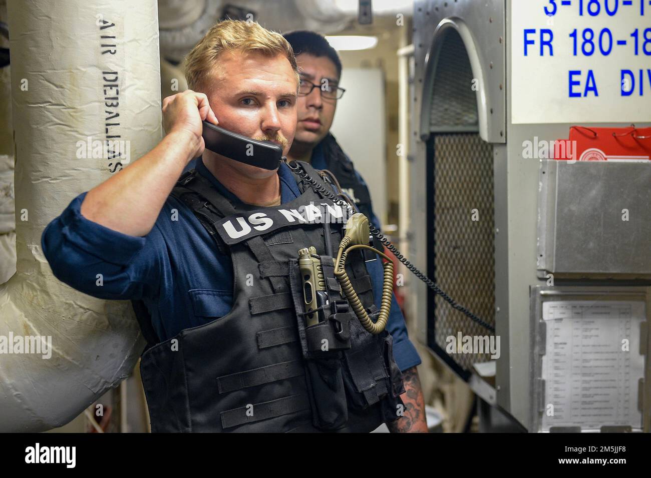 PHILIPPINE SEA (March 19, 2022) Boatswain’s Mate 1st Class Oden Rogers, from Spicer, Minn., assigned to the amphibious transport dock ship USS Green Bay (LPD 20), establishes communications in the ship’s armory during an antiterrorism training team drill. Green Bay, part of Expeditionary Strike Group 7, along with the 31st Marine Expeditionary Unit (MEU), is operating in the U.S. 7th Fleet area of responsibility to enhance interoperability with allies and partners and serve as a ready response force to defend peace and stability in the Indo-Pacific region. Stock Photo
