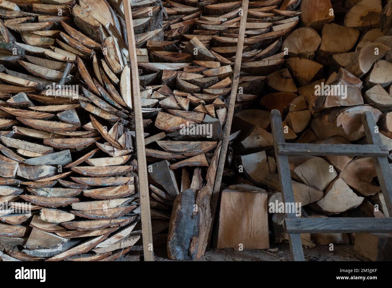 Stock of beechwood pieces stored by household for heating during winter creates attractive visual patterns and relaxing composition Stock Photo