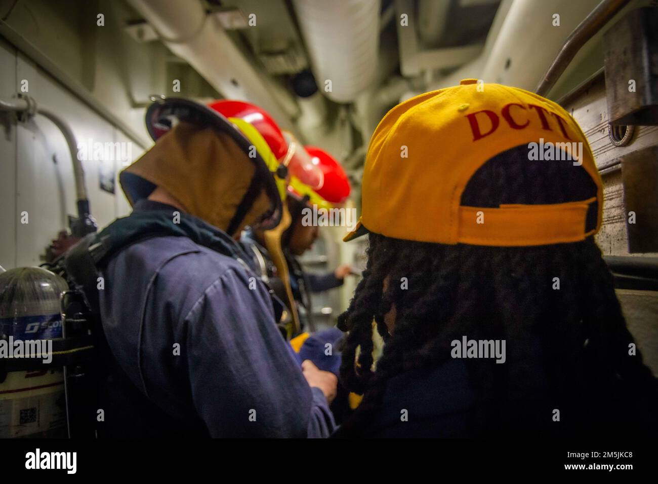 220319-N-FS190-2025 ATLANTIC OCEAN (March 19, 2022) Retail Specialist 1st Class Keonna Wilcox, assigned to the Arleigh Burke-class guided-missile destroyer USS Truxtun (DDG 103), directs Sailors as a damage control training team (DCTT) member during a damage control drill for Task Force Exercise (TFEX), March 19, 2022. TFEX is a scenario driven exercise that serves as certification for independent deploying ships and is designated to test mission readiness and performance in integrated operations. Truxtun is underway for Carrier Strike Group (CSG) 4 training evolutions. Stock Photo