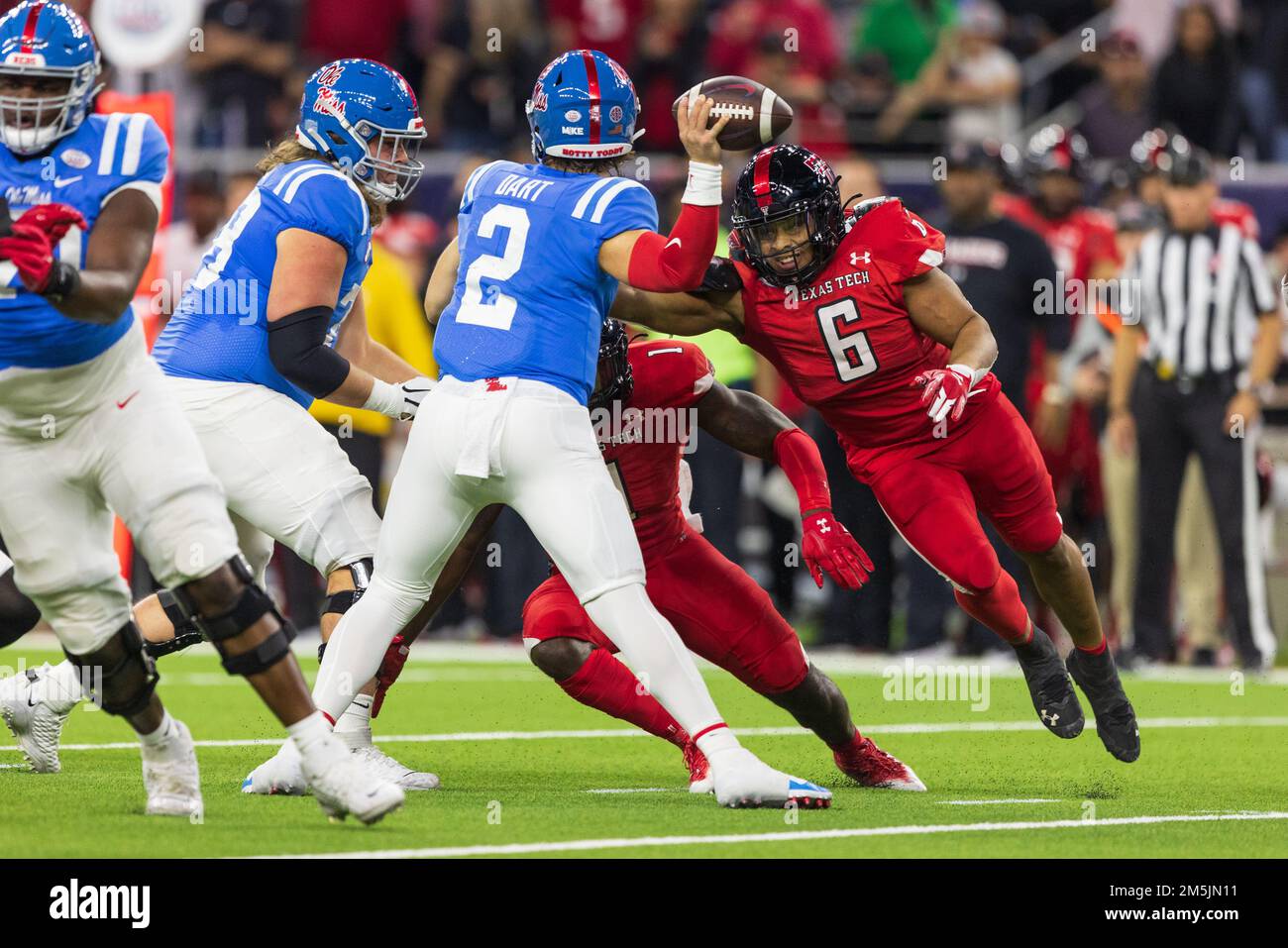 Ole Miss Rebels quarterback Jaxson Dart (2) passes as Texas Tech Red Raiders linebacker Kosi Eldridge (6) turns the corner during the 2022 TaxAct Texa Stock Photo