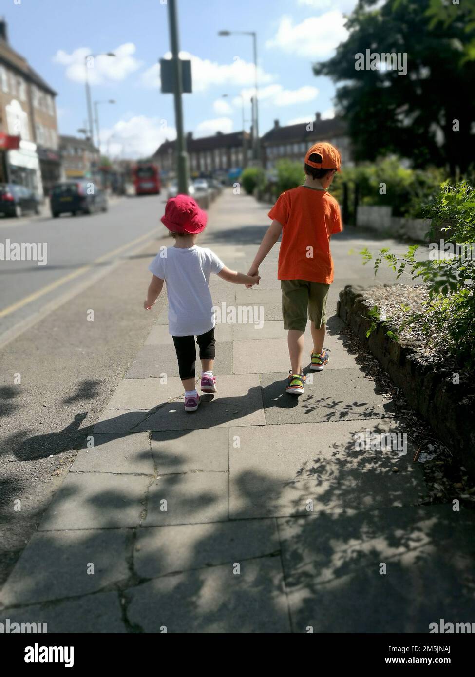 Siblings holding hands Stock Photo - Alamy