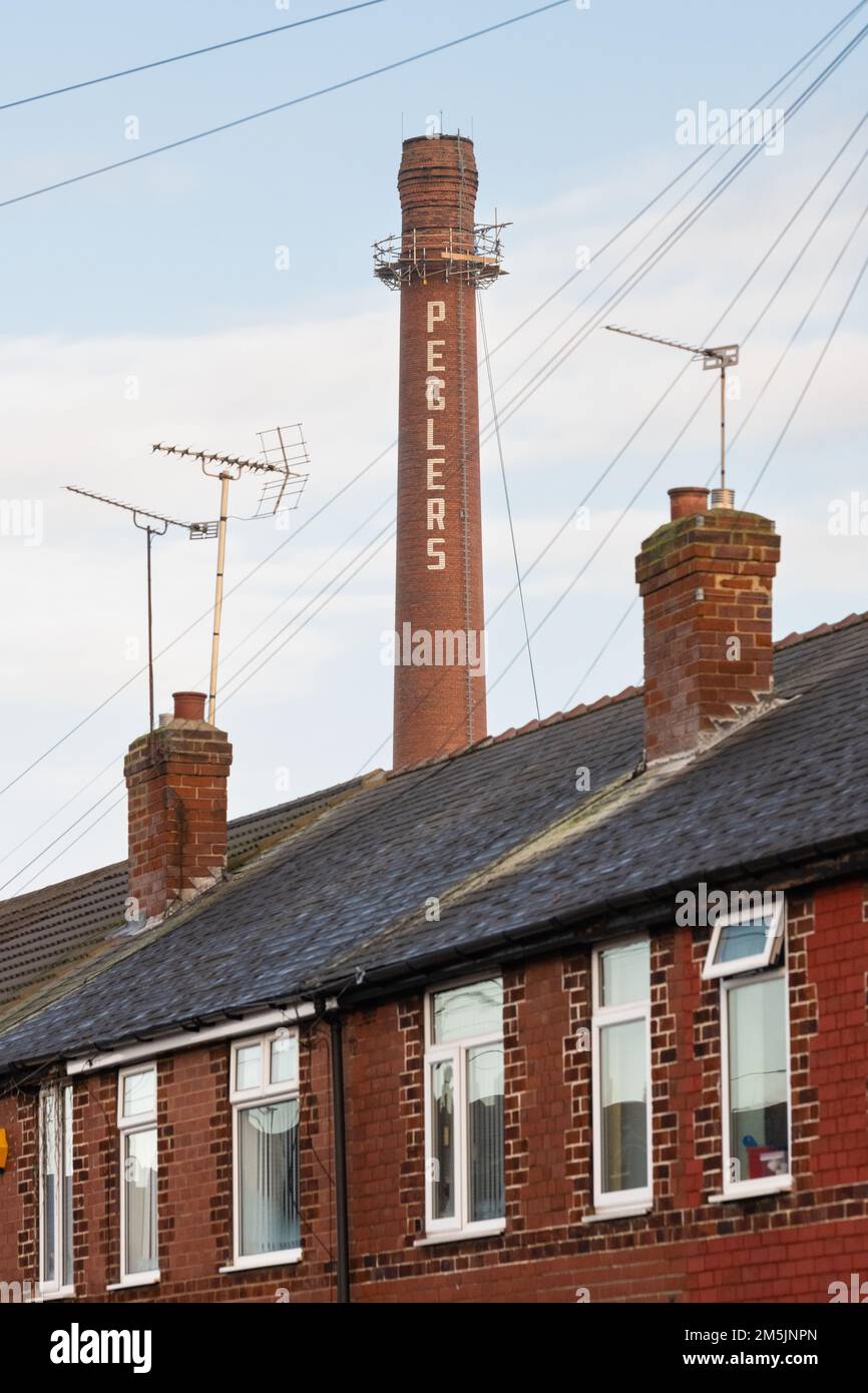 Terraced housing and Peglers chimney, Balby, Doncaster, South Yorkshire, England UK Stock Photo