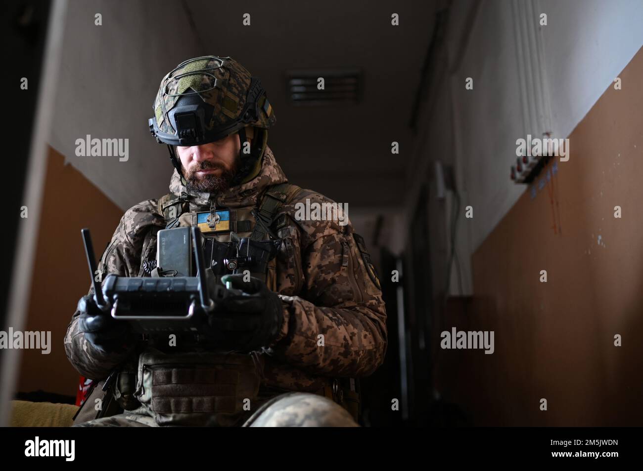 A Ukrainian servicemember operates a surveillance drone with a handheld ...