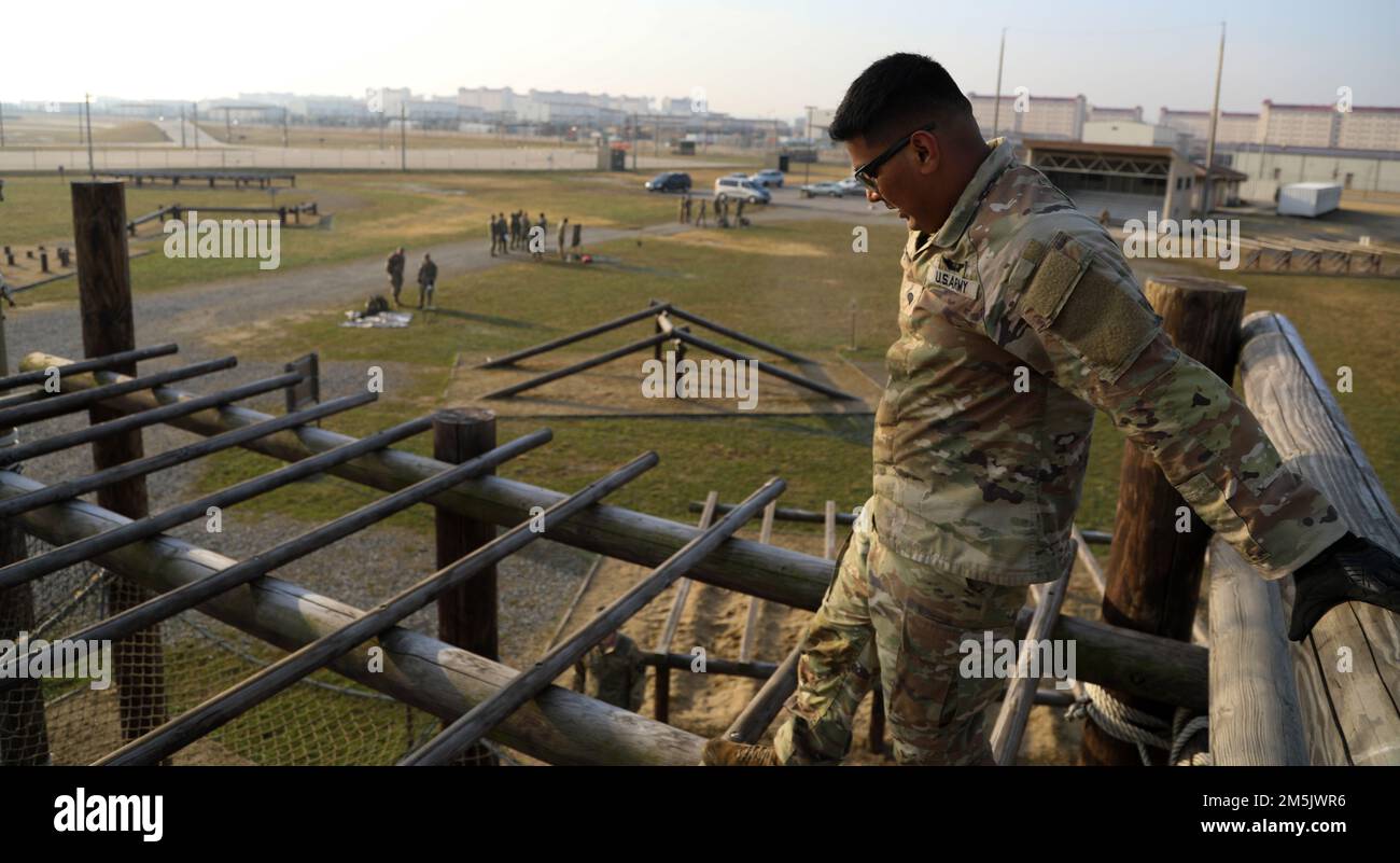 Spc. Jimesh Patel a UH-60 Helicopter Repairer assigned to 3-2 General Support Aviation Battalion, 2nd Combat Aviation Brigade, 2nd Infantry Division, participates in the Best Warrior Competition Obstacle Course, 21 Mar. 2022, Camp Humphreys, Republic of Korea. The BWC is held to recognize the best Soldiers of the 2CAB through various tests including a ruck march, obstacle course and a Soldier of the quarter board. Stock Photo