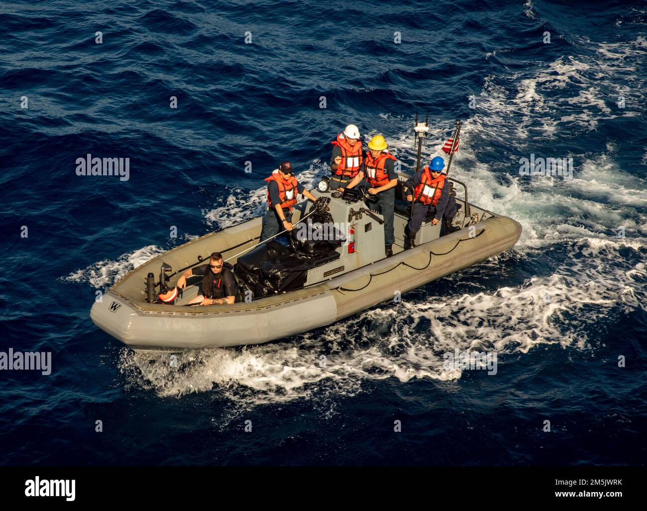SOUTH CHINA SEA (March 12, 2022) Sailors aboard a Rigid-hull Inflatable Boat (RHIB)return to Arleigh Burke-class guided-missile destroyer USS Ralph Johnson (DDG 114). Ralph Johnson is assigned to Task Force 71/Destroyer Squadron (DESRON) 15, the Navy’s largest forward-deployed DESRON and the U.S. 7th fleet’s principal surface force. Stock Photo