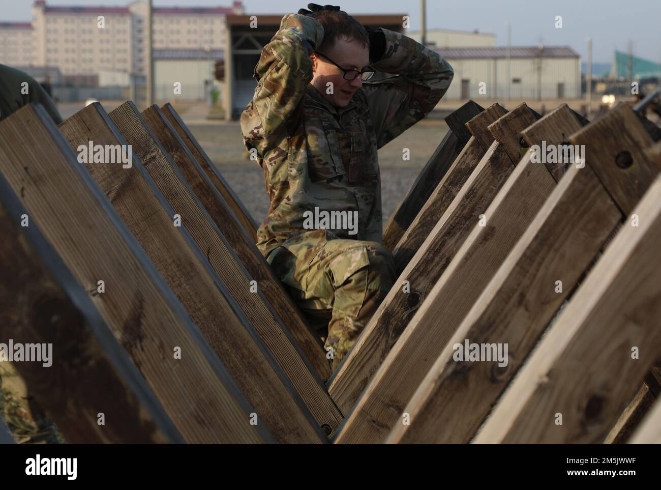 Pfc. Jacob Cronan a Human Resources Specialist assigned to 602nd Aviation Support Battalion, 2nd Combat Aviation Brigade, 2nd Infantry Division, attempts to weave through the wooden angled obstacle during course, 21 Mar. 2022, Camp Humphreys, Republic of Korea. The BWC is held to recognize the best Soldiers of the 2CAB through various tests including a ruck march, obstacle course and a Soldier of the quarter board. Stock Photo