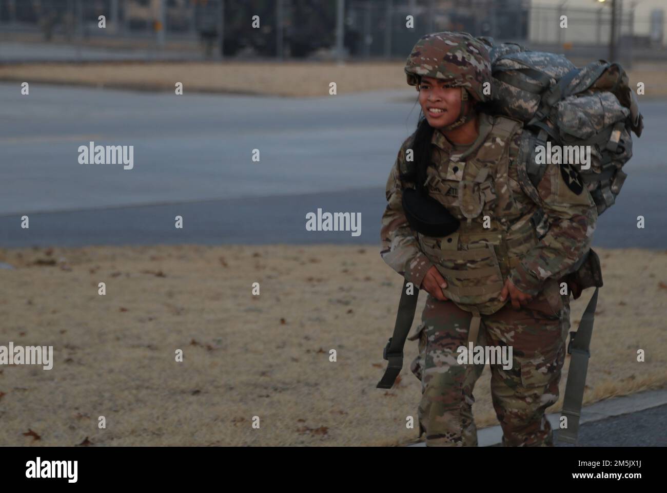 Spc. Abegail Crossett a Geospatial Intelligence Imagery Analyst assigned to 2nd Combat Aviation Brigade, 2nd Infantry Division, participates in the ruck march for the Best Warrior Competition, 21 Mar. 2022, Camp Humphreys, Republic of Korea. The BWC is held to recognize the best Soldiers of the 2CAB through various tests including a ruck march, obstacle course and a Soldier of the quarter board. Stock Photo