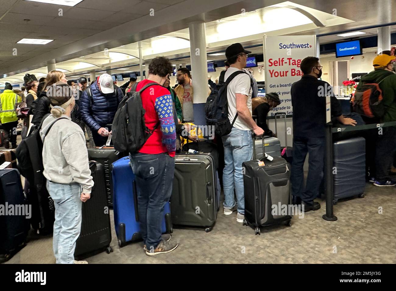 Passengers wait in line to check in luggage at the Southwest Airlines
