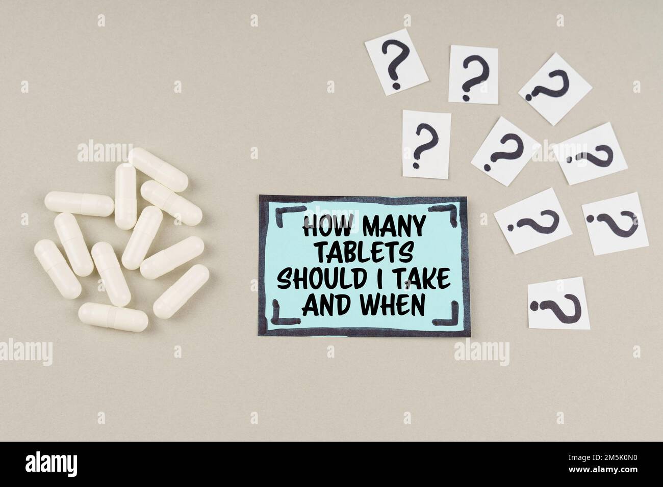 Medical Concept On A Gray Surface There Are Question Marks And A Blue medical-concept-on-a-gray-surface-there-are-question-marks-and-a-blue