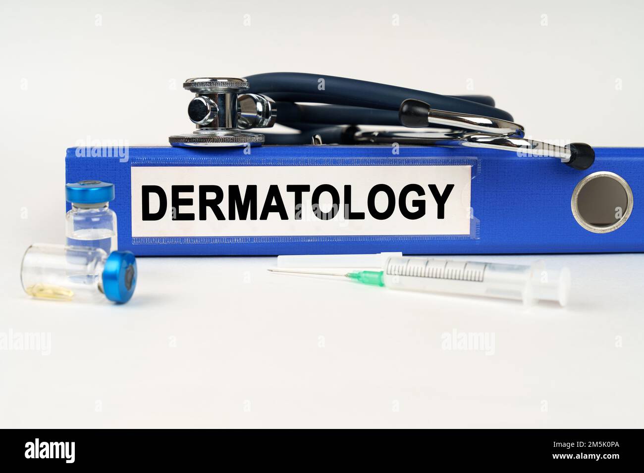 Medical concept. On a white surface, a syringe, a stethoscope and a ...