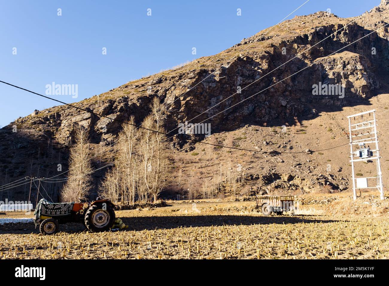 Tactor with disk harrow on ploughing field. Cultivated land and soil