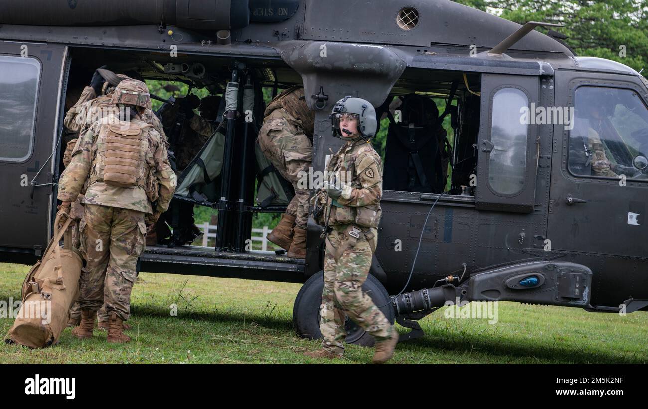 Soldiers from Alpha Company, 29th Brigade Engineer Battalion, 3rd Brigade Combat Team, 25th Infantry Division, board a U.S. Army UH-60 Black Hawk, assigned to the 2nd Assault Helicopter Battalion, 25th Aviation Regiment, 25th Infantry Division, for an air assault, Mar. 22, 2022, Fort Thanarat, Thailand. Air assaults allow troops to rapidly insert near an objective and utilize the element of surprise during the attack. Stock Photo