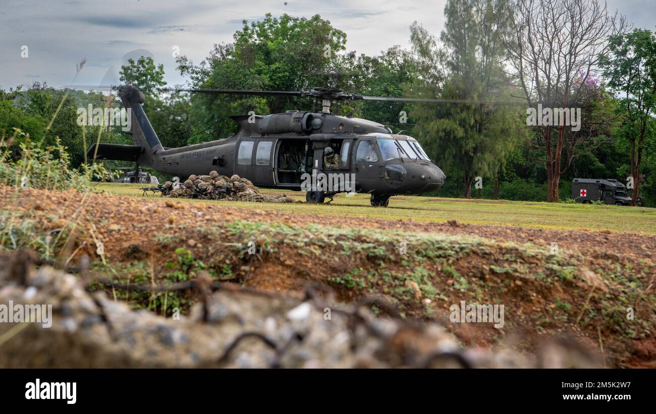 Soldiers from Alpha Company, 29th Brigade Engineer Battalion, 3rd Brigade Combat Team, 25th Infantry Division, exit a U.S. Army UH-60 Black Hawk, assigned to the 2nd Assault Helicopter Battalion, 25th Aviation Regiment, 25th Infantry Division, during an air assault, Mar. 22, 2022, Fort Thanarat, Thailand. Air assaults allow troops to rapidly insert near an objective and utilize the element of surprise during the attack. Stock Photo