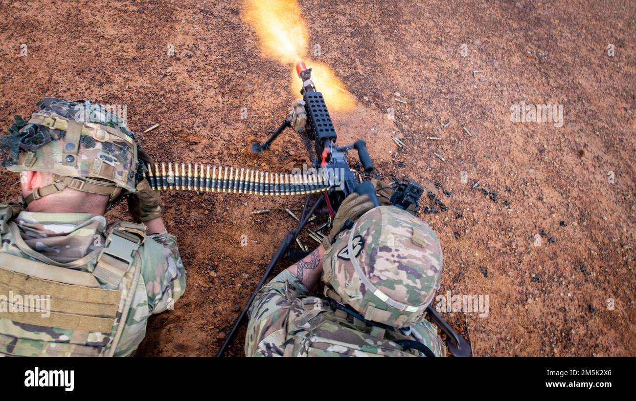 A M240B machine gun crew, Alpha Company, 29th Brigade Engineer Battalion, 3rd Brigade Combat Team, 25th Infantry Division, engages simulated targets during an air assault, Mar. 22, 2022, Fort Thanarat, Thailand. Air assaults allow troops to rapidly insert near an objective and utilize the element of surprise during the attack. Stock Photo