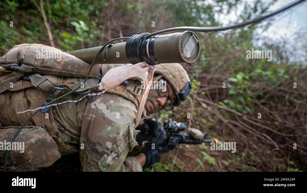 A U.S. Army Soldier from Alpha Company, 29th Brigade Engineer Battalion, 3rd Brigade Combat Team, 25th Infantry Division, carries a Bangalore torpedo to remove obstacles blocking an objective during an air assault, Mar. 22, 2022, Fort Thanarat, Thailand. Air assaults allow troops to rapidly insert near an objective and utilize the element of surprise during the attack. Stock Photo