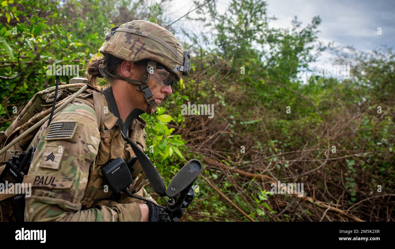 Sgt. McKenzie Paul, Alpha Company, 29th Brigade Engineer Battalion, 3rd Brigade Combat Team, 25th Infantry Division, moves towards an objective during an air assault, Mar. 22, 2022, Fort Thanarat, Thailand. Air assaults allow troops to rapidly insert near an objective and utilize the element of surprise during the attack. Stock Photo