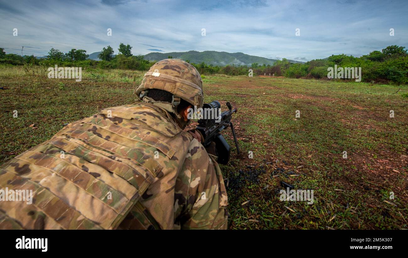 A M249 light machine gunner, Alpha Company, 29th Brigade Engineer Battalion, 3rd Brigade Combat Team, 25th Infantry Division, engages simulated targets during an air assault, Mar. 22, 2022, Fort Thanarat, Thailand. Air assaults allow troops to rapidly insert near an objective and utilize the element of surprise during the attack. Stock Photo