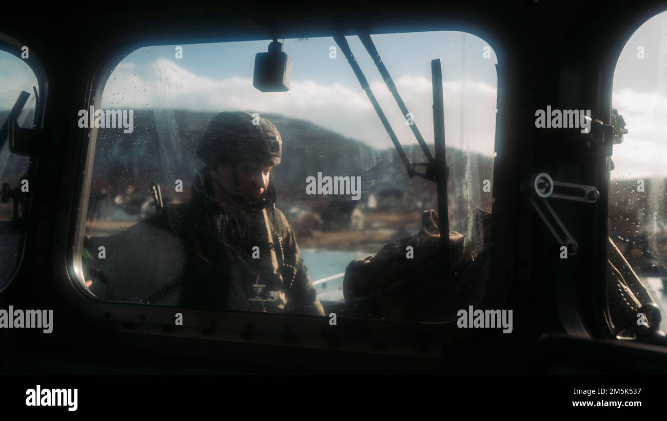 A U.S. Marine disembarks a Royal Netherlands Navy Landing Craft Vehicle Personnel during an amphibious beach landing for Exercise Cold Response 2022, Norway, March 21, 2022. The Marines are assigned to II Marine Expeditionary Force. Exercise Cold Response '22 is a biennial Norwegian national readiness and defense exercise that takes place across Norway, with participation from each of its military services, as well as from 26 additional NATO allied nations and regional partners. Stock Photo