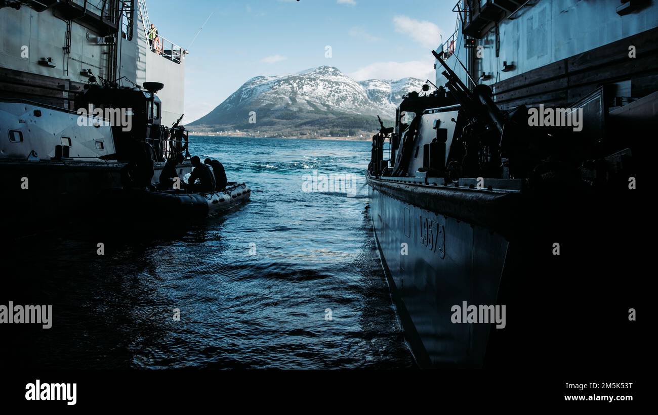 A Royal Netherlands Navy Landing Craft Vehicle Personnel is anchored as U.S. Marines prepare to disembark the HNLMS Rotterdam for an amphibious beach landing during Exercise Cold Response 2022, Norway, March 21, 2022. The Marines are assigned to 3rd Battalion, 6th Marine Regiment, 2d Marine Division, II Marine Expeditionary Force. Exercise Cold Response '22 is a biennial Norwegian national readiness and defense exercise that takes place across Norway, with participation from each of its military services, as well as from 26 additional NATO allied nations and regional partners. Stock Photo