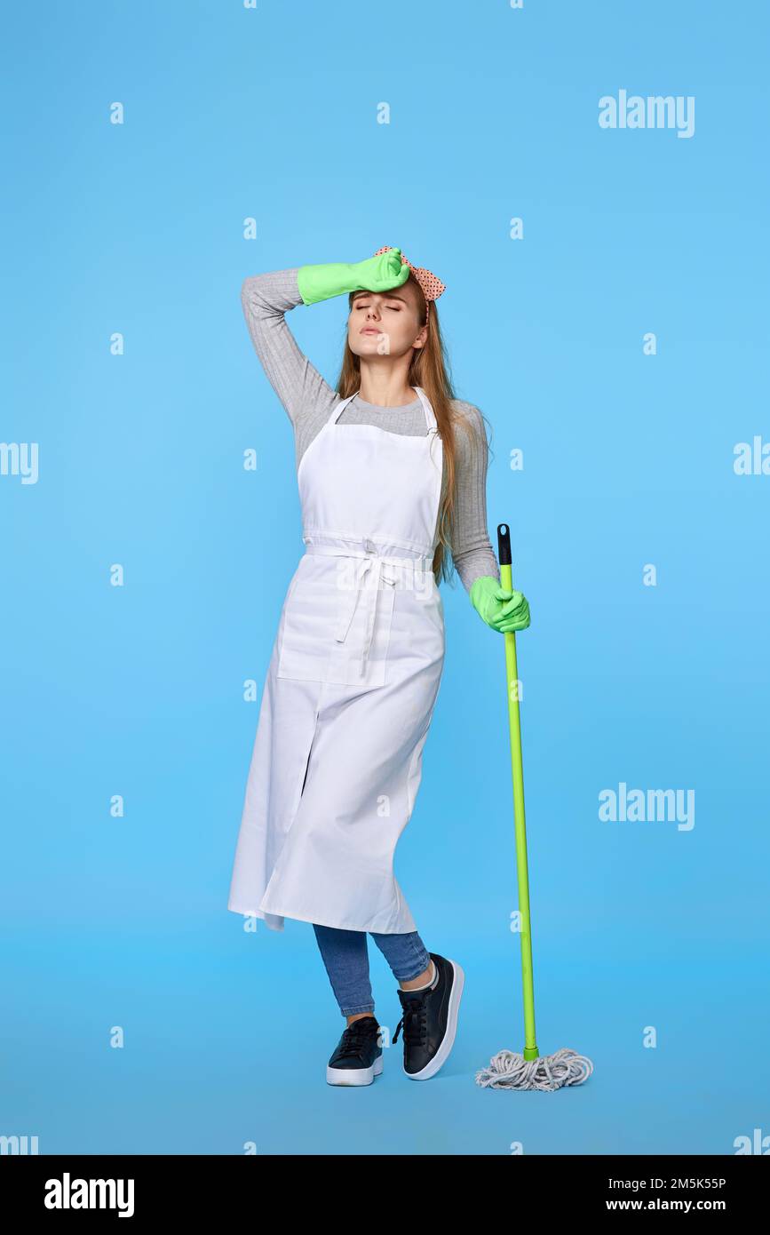 woman in rubber gloves and cleaner apron washing floor with mop Stock ...