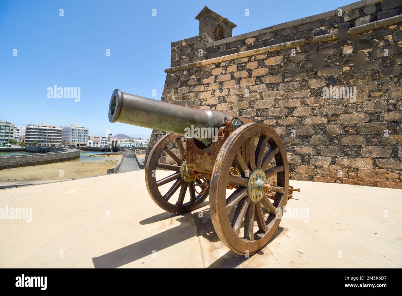 Old cannon of the Castillo de San Gabriel in Arrecife pointing towards the bay Stock Photo