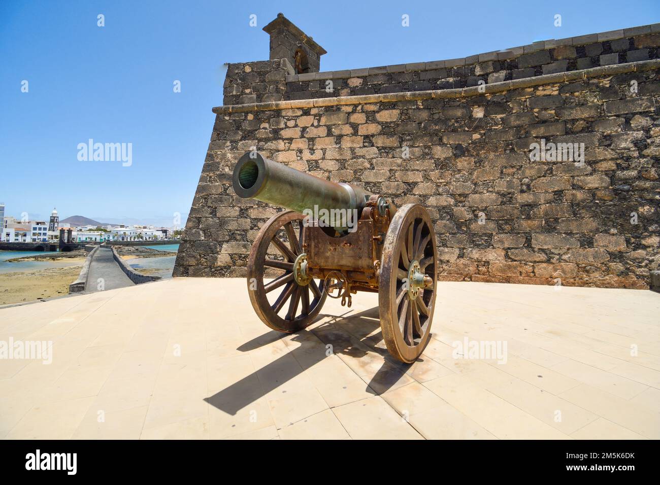 Old cannon of the Castillo de San Gabriel in Arrecife pointing towards the bay Stock Photo