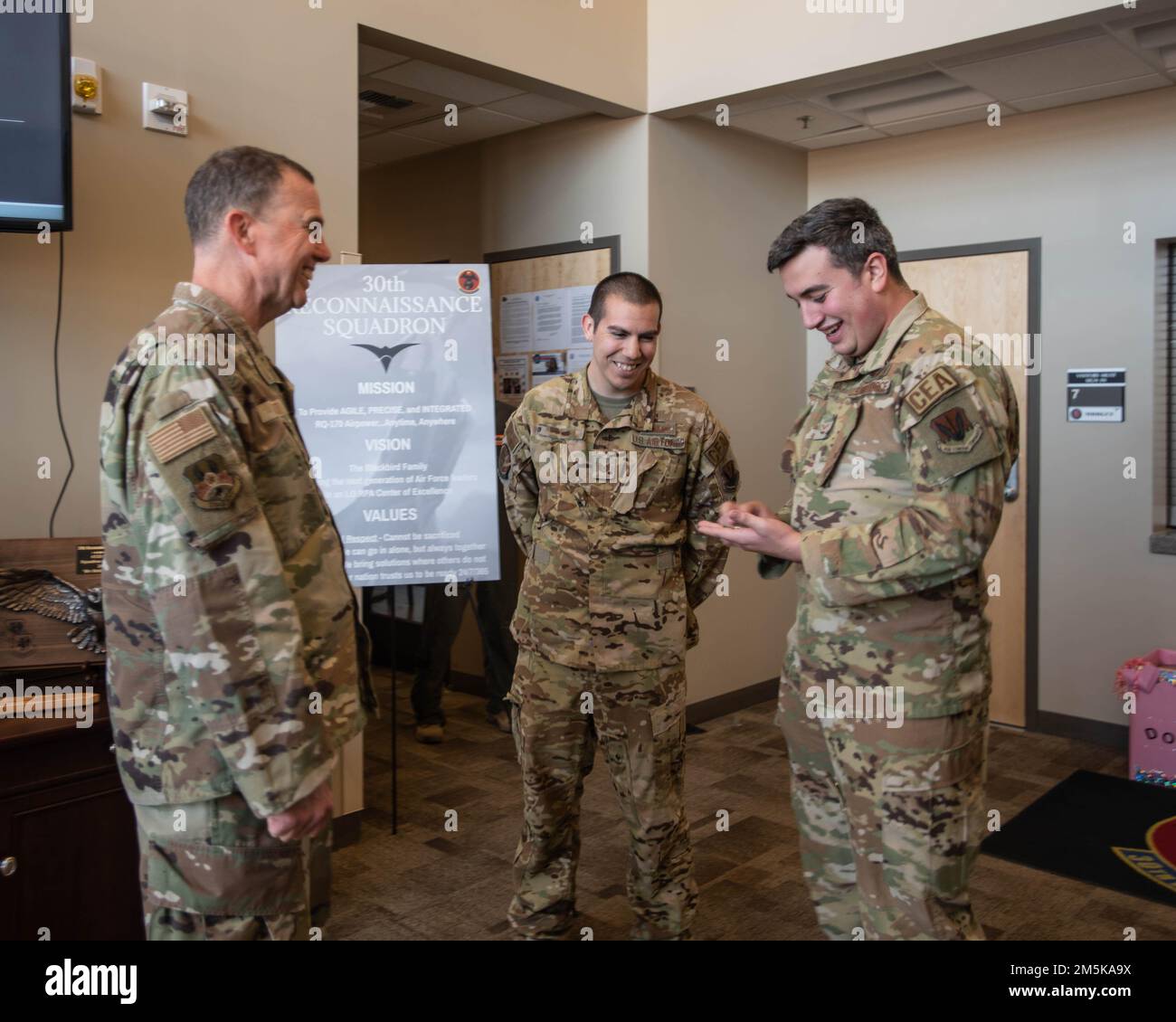 U.S. Air Force Lt. Gen. Gregory Guillot, commander of Air Forces Central Command, presents an Airman assigned to the 432nd Wing/432nd Air Expeditionary Wing, with a coin for outstanding performance at Creech Air Force Base, Nevada, March 21, 2022. Guillot visited with the 30th Reconnaissance Squadron, 17th Attack Group, 732nd Operations Group, and Persistent Attack and Reconnaissance Operations Center to show his support and boost morale among the Airmen who work to make a mission of air dominance possible. Stock Photo